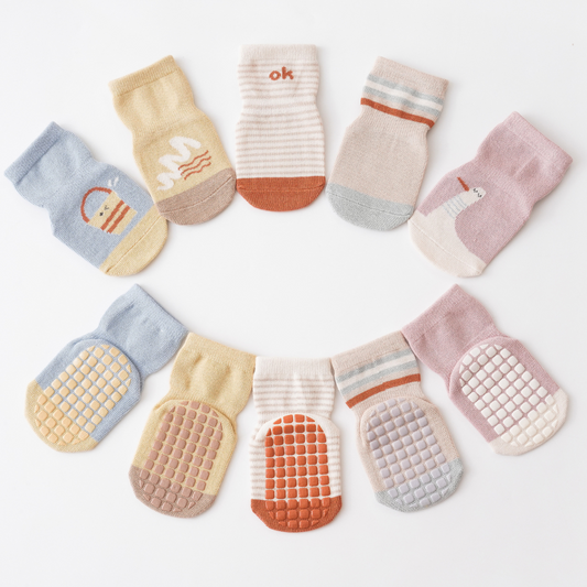 How do grips on infant socks improve safety?